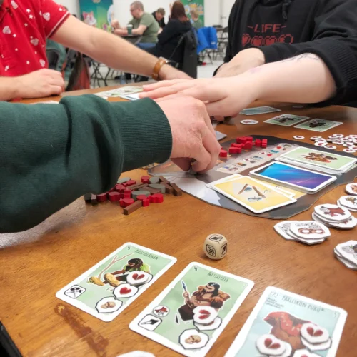 Arms reaching across the Paleo board.