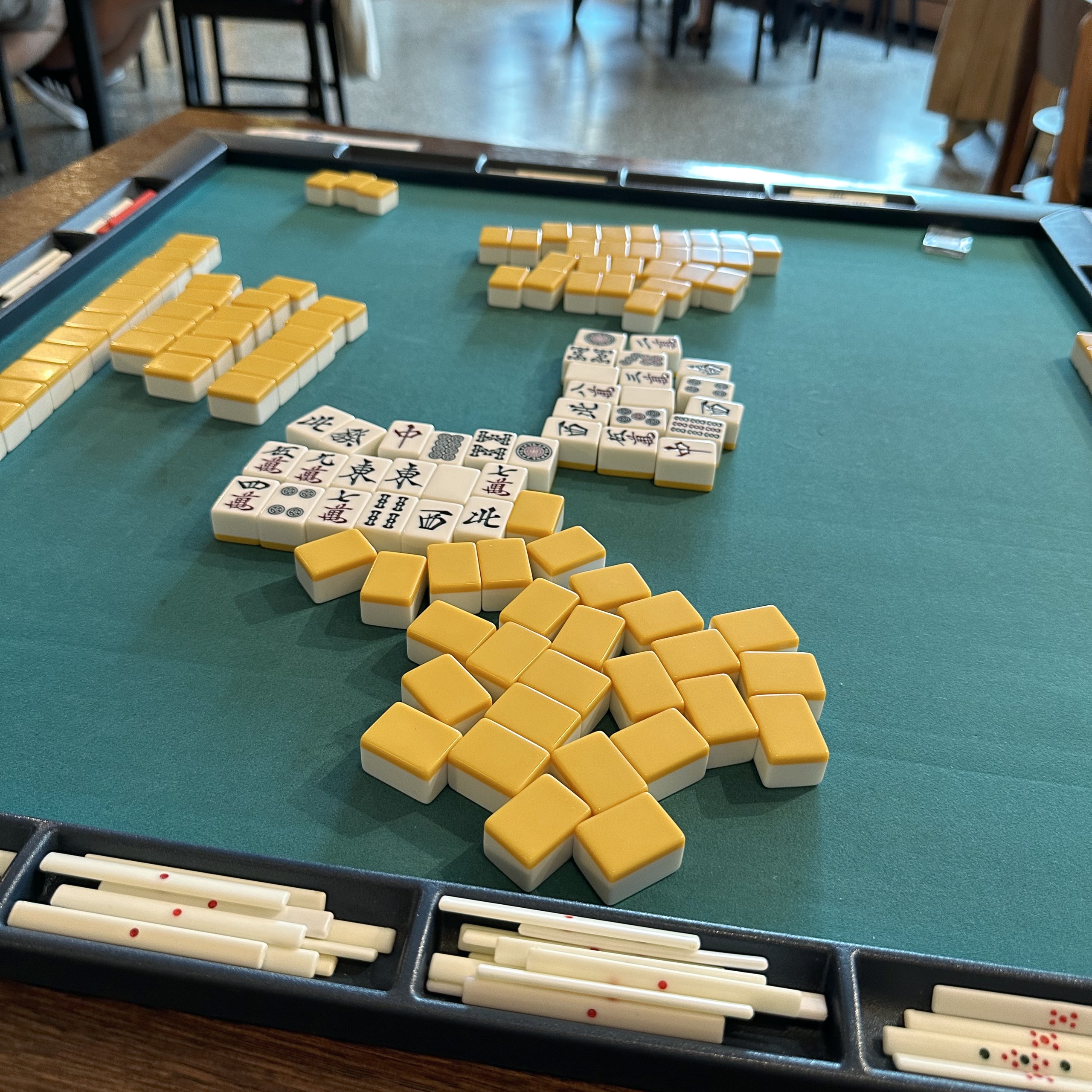 Mahjong tiles on a junk mat.
