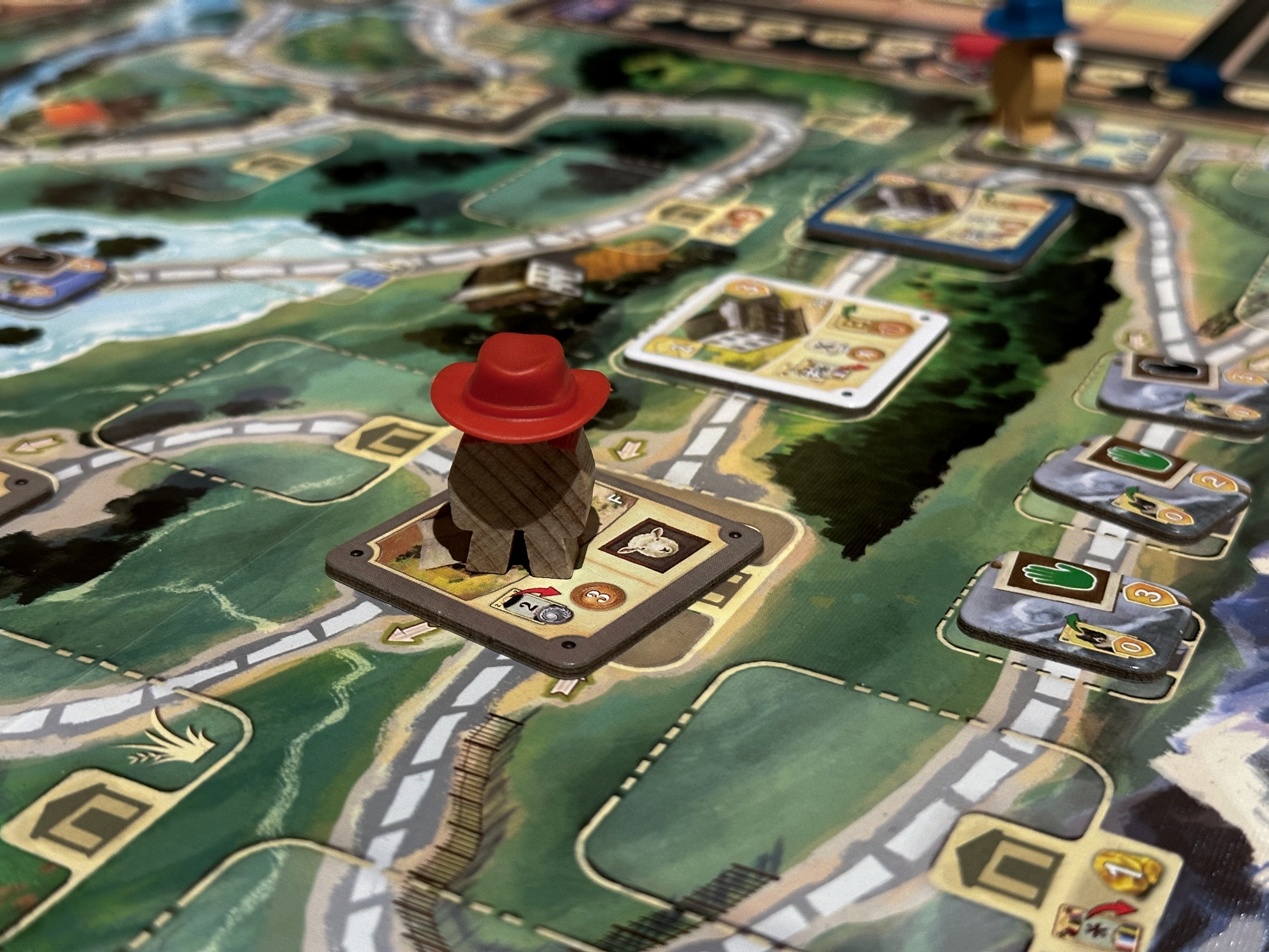 A meeple wearing a red hat.