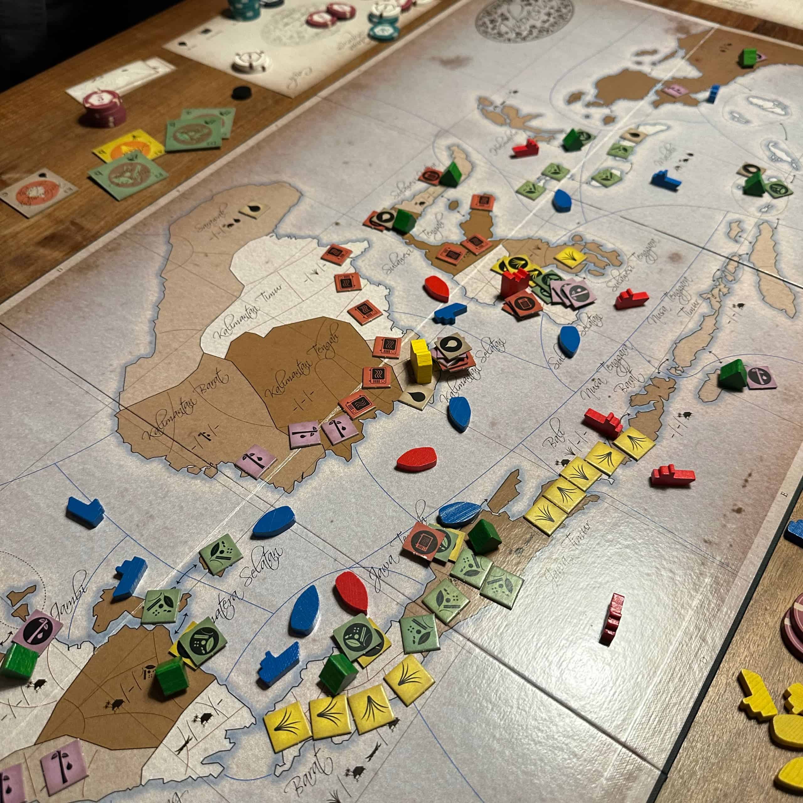 The board of Indonesia, depicting the Indonesian archipelago. Cardboard chits depict rubber, rice and microwave meal production, and wooden ships depict shipping lines. There's a lot of action in Java in in southern Borneo.